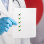 a,doctor,holding,a,white,paper,with,a,checklist,while