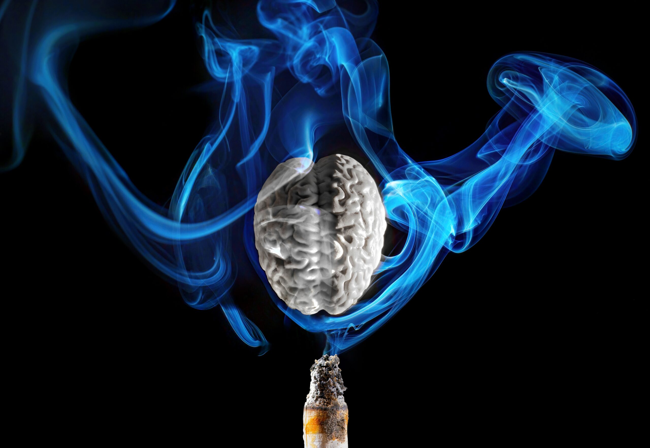 deteriorated,gray,brain,with,smoke,spiraling,from,a,cigarette,on